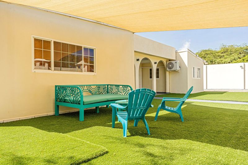 Garden lounge under the shade sail